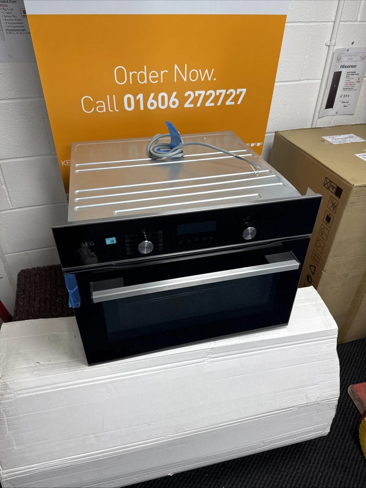 AEG 6000 Series GK6NK401B Combi Quick Compact Built-in Combination Microwave Oven in Black from HomeWise Appliances. Shop photo in front of call to action sales banner. Call 01606 272727