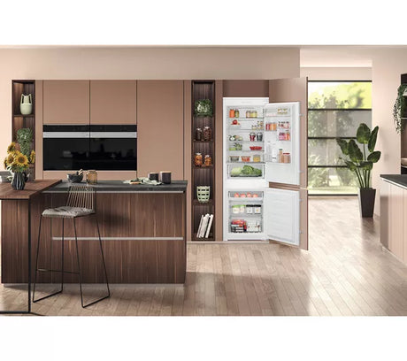 Hotpoint HTC18 T112 UK 70/30 No Frost Integrated Fridge Freezer with Sliding Hinge - E Rated from HomeWise Appliances. Stock photo of the fridge freezer in a open plan kitchen setting.