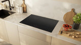 Neff T58FHW1L0 N70 80cm 5-Zone Induction Hob with Twist Touch® from HomeWise Appliances. Stock photo of the hob fitted in a worktop in a kitchen surround.