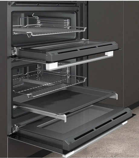 Neff N50 J1ACE2HN0b Double Built under Oven from HomeWise Appliances. Stock photo showing oven doors open with telescopic rails and trays.