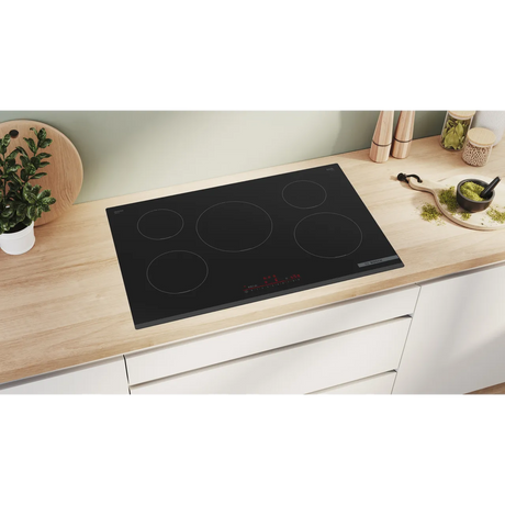 Bosch Series 6 PIV831HB1E 80cm 5-Zone Induction Hob in Black - Wi-Fi Enabled in a modern kitchen looking sleek and elegant.