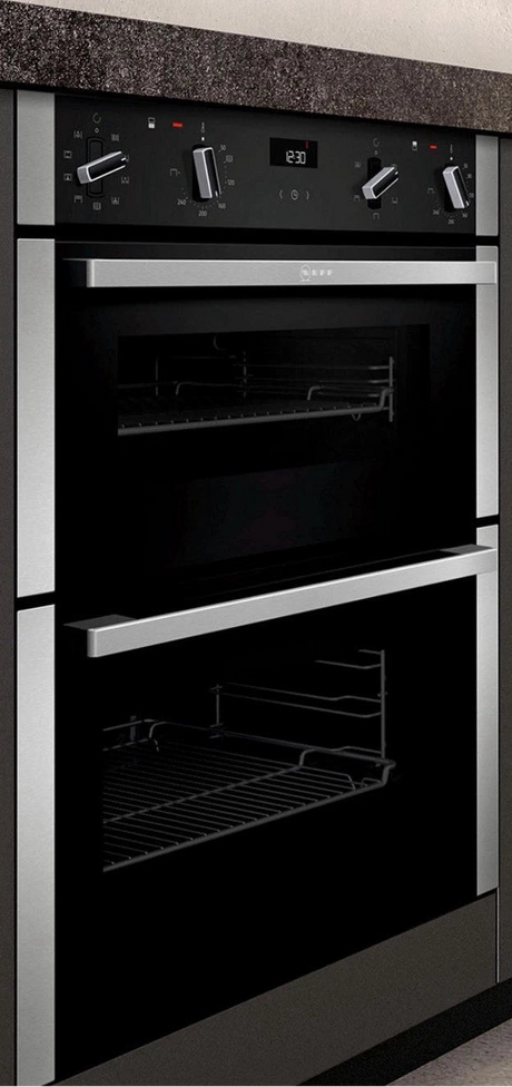 Neff N50 J1ACE2HN0b Double Built under Oven from HomeWise Appliances. Stock photo showing oven in a kitchen cabinet under a worktop.