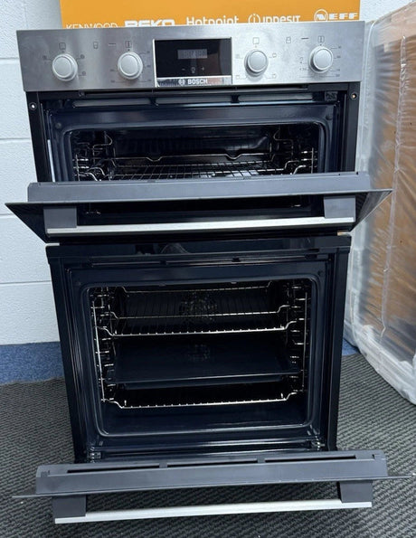 Bosch Series 2 MHA133BR0B (79) Built In Electric Double Oven in Stainless Steel from HomeWise Appliances. Showroom photo showing close up of oven with doors open showing the main oven cavity is fan assisted.