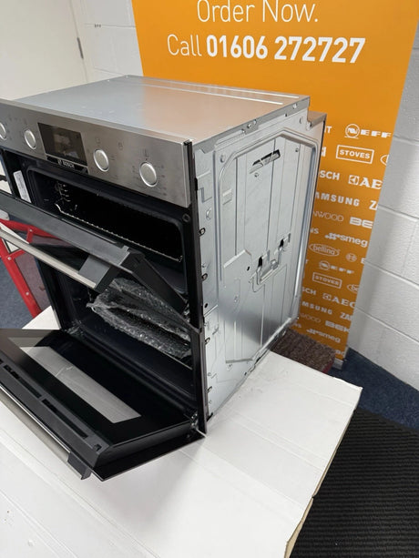 Bosch Series 4 NBS533BS0B Electric Built-Under Electric Double Oven in Stainless Steel from HomeWise Appliances. Showroom photo showing the oven angled with doors open and the front and right side on display.